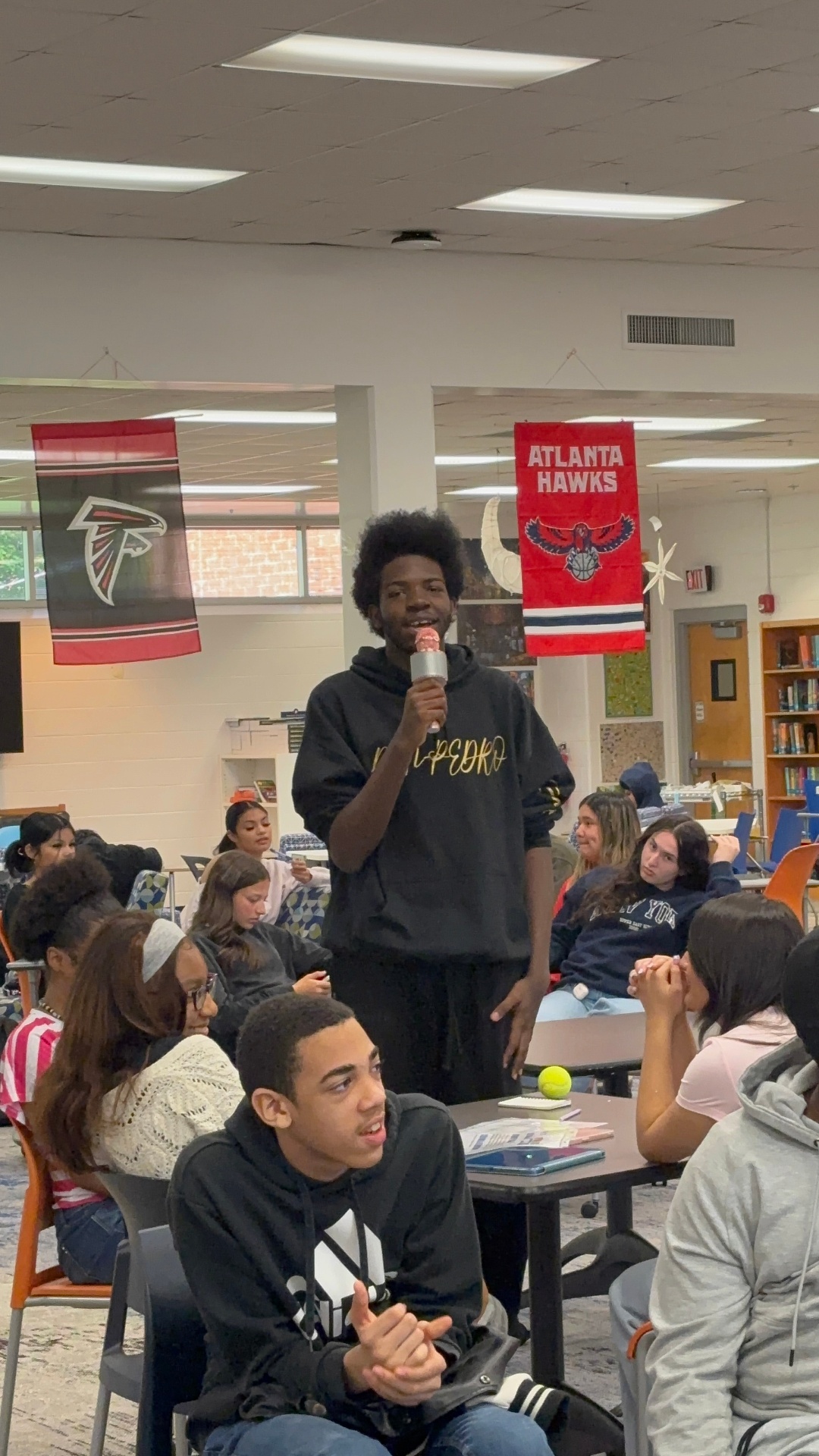Student speaking to peers